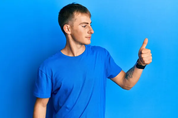 Junger Kaukasischer Mann Lässigem Blauem Shirt Sieht Stolz Aus Lächelt — Stockfoto