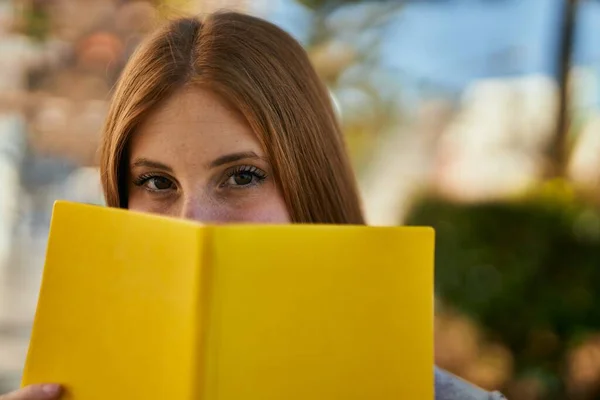 Young Redhead Girl Smiling Happy Covering Face Book City — Stock Photo, Image