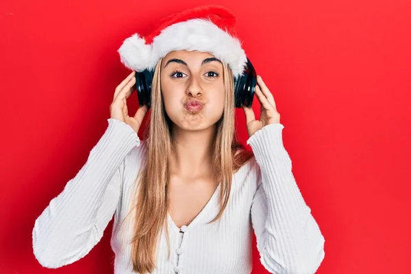 Hermosa Mujer Hispana Con Sombrero Navidad Auriculares Hinchando Mejillas Con — Foto de Stock
