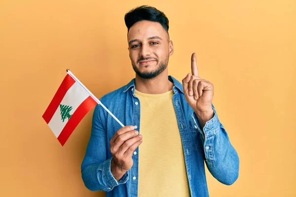 Mladý Arabský Muž Držící Libanonskou Vlajku Usmívající Nápadem Nebo Otázkou — Stock fotografie