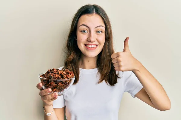 Young Brunette Woman Holding Bowl Star Anise Smiling Happy Positive — Stock Photo, Image