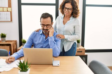 Ofiste mutlu bir şekilde flört eden iki orta yaşlı iş adamı..
