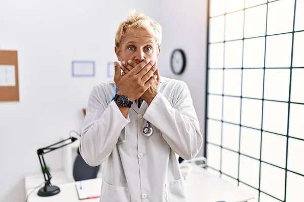 Young Blond Man Wearing Doctor Uniform Stethoscope Clinic Shocked Covering — Stock Photo, Image