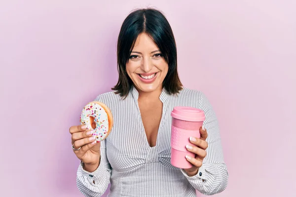 Young Hispanic Woman Eating Doughnut Drinking Coffee Smiling Laughing Hard — Stock Photo, Image