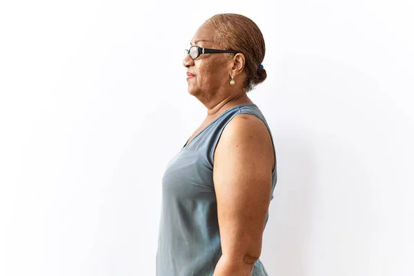 Dojrzała Latynoska Kobieta Nosi Okulary Stojące Odosobnionym Tle Patrząc Bok — Zdjęcie stockowe