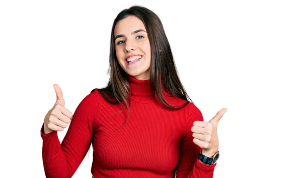 Young Brunette Teenager Wearing Red Turtleneck Sweater Success Sign Doing — Stockfoto
