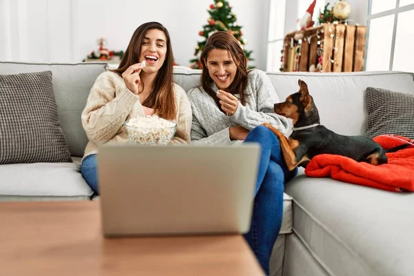 Duas Mulheres Assistindo Filme Sentado Com Cão Pela Árvore Natal — Fotografia de Stock