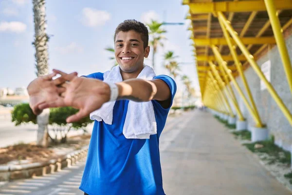 Young Hispanic Man Stretching Arms Muscles Outdoors — Stock Photo, Image