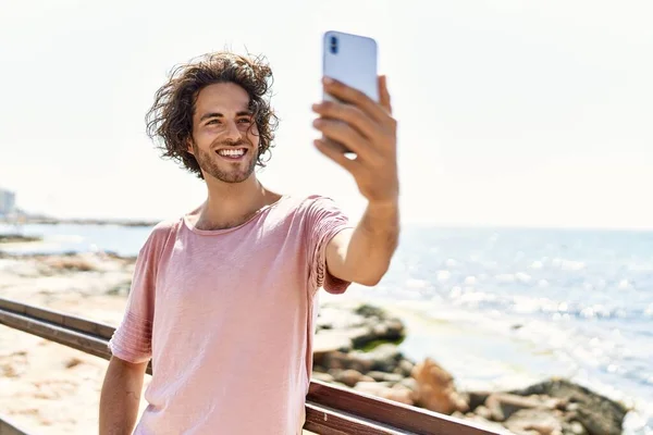 Mutlu Gülümseyen Genç Spanyol Adam Sahilde Duran Akıllı Telefonun Yanında — Stok fotoğraf
