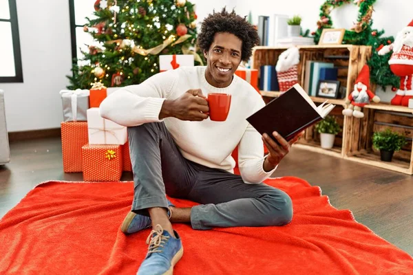 Young African American Man Reading Book Drinking Coffee Sitting Floor — Fotografia de Stock