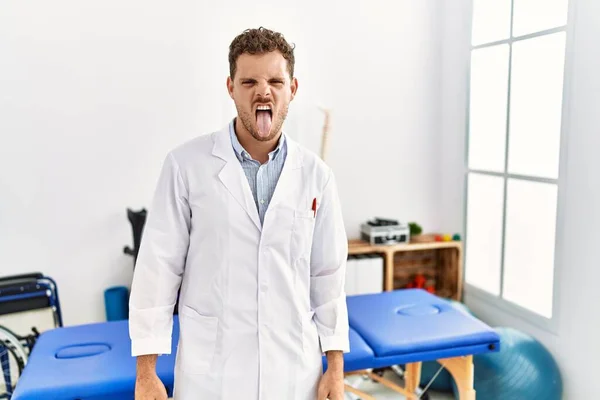 Handsome Young Man Working Pain Recovery Clinic Sticking Tongue Out — Stock Photo, Image