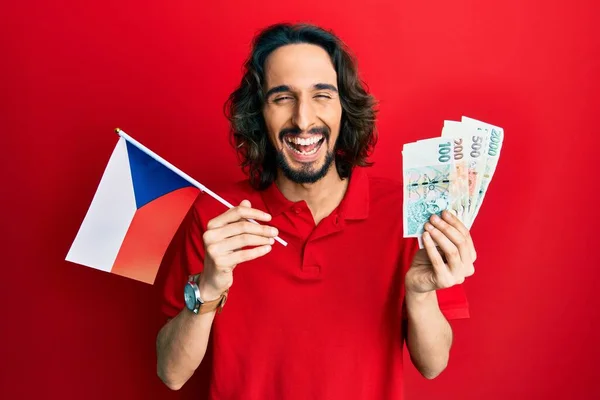 Joven Hombre Hispano Sosteniendo Bandera República Checa Billetes Corea Sonriendo —  Fotos de Stock