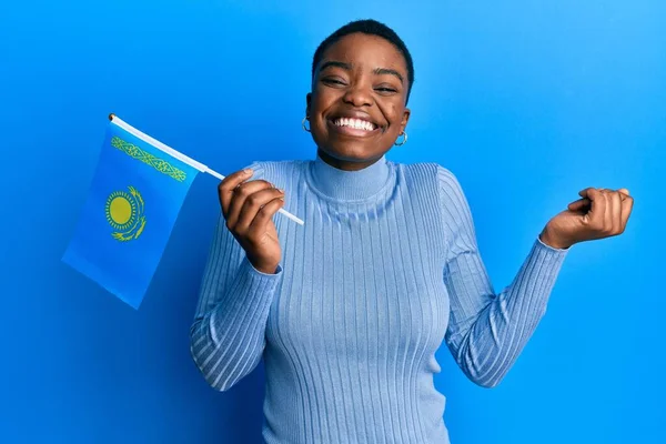 Young African American Woman Holding Kazakhstan Flag Screaming Proud Celebrating — Stock Photo, Image