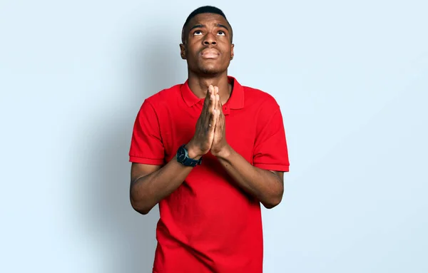 Young African American Man Wearing Casual Red Shirt Begging Praying — Stock Photo, Image