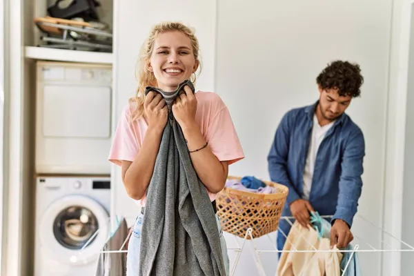 Young Couple Smiling Happy Doing Laundry Woman Smelling Clean Clothes — Stock Photo, Image