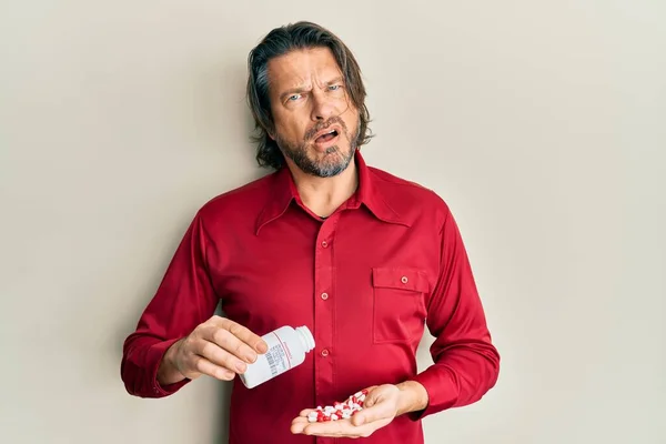 Middle Age Handsome Man Taking Pills Shock Face Looking Skeptical — Stock Photo, Image