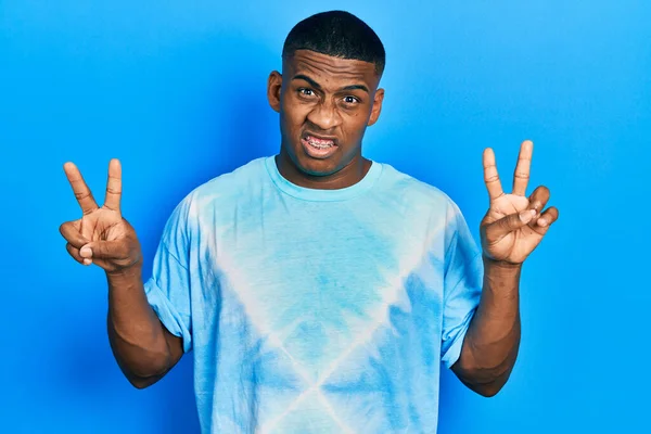 Young Black Man Doing Victory Sign Peace Gesture Clueless Confused — Stock Photo, Image