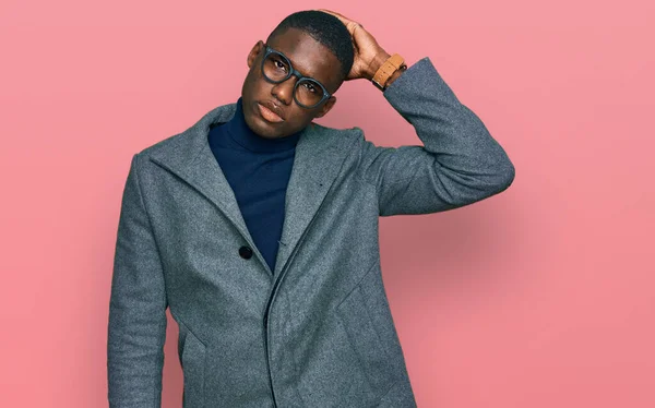穿着商务服装和眼镜的年轻的非洲裔美国人对问题感到困惑和疑惑 拿不定主意 手拿着头思考 沉思的概念 — 图库照片