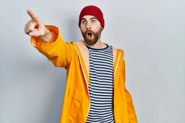 Homem Caucasiano Com Barba Vestindo Capa Amarela Apontando Com Dedo — Fotografia de Stock