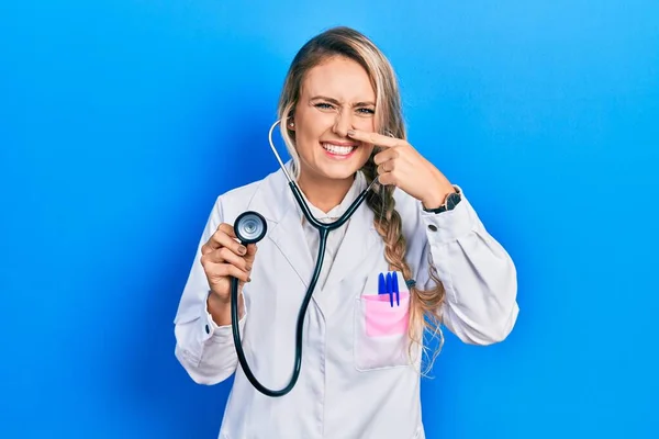 Beautiful Young Blonde Doctor Woman Holding Stethoscope Pointing Hand Finger — Stock Photo, Image