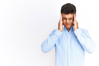 Young hispanic man wearing business shirt standing over isolated background with hand on head, headache because stress. suffering migraine. 