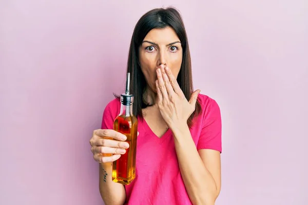 Young Hispanic Woman Holding Olive Oil Can Covering Mouth Hand — Stock Photo, Image