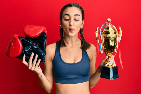 Young Brunette Girl Holding Boxer Gloves Trophy Making Fish Face — 图库照片