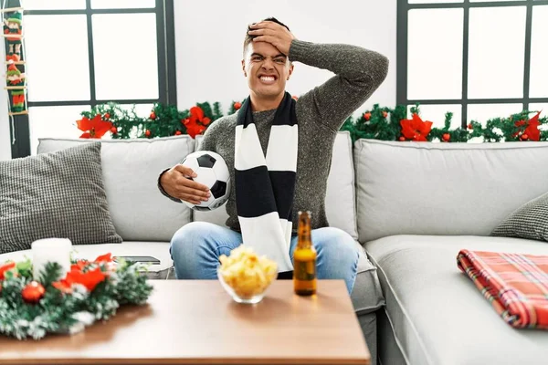 Young Hispanic Man Football Hooligan Holding Ball Beer Stressed Frustrated — Zdjęcie stockowe