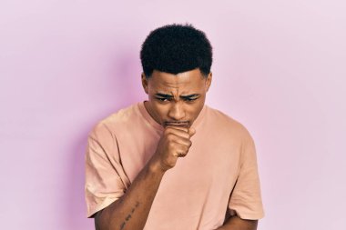 Young african american man wearing casual t shirt screaming proud, celebrating victory and success very excited with raised arms 