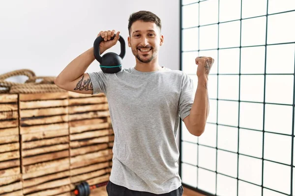 Young Handsome Man Wearing Sportswear Using Dumbbells Screaming Proud Celebrating — Φωτογραφία Αρχείου