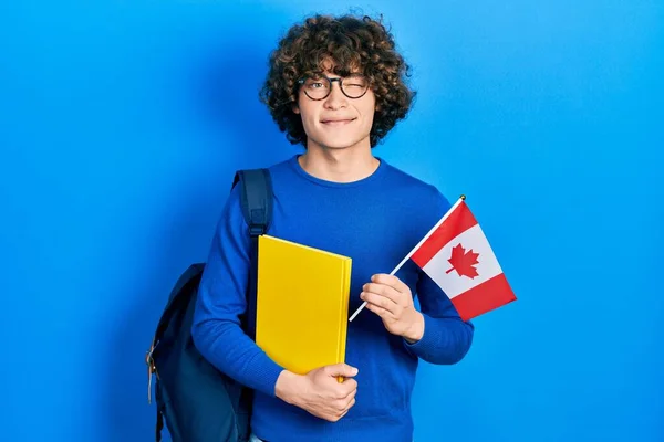 Handsome Young Man Exchange Student Holding Canada Flag Winking Looking — Stockfoto