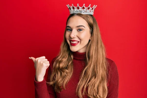 Young Blonde Woman Wearing Princess Crown Pointing Thumb Side Smiling — Stock Photo, Image