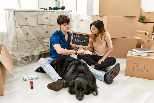 Young Caucasian Couple Dog Holding Our First Home Blackboard New — Stok Foto