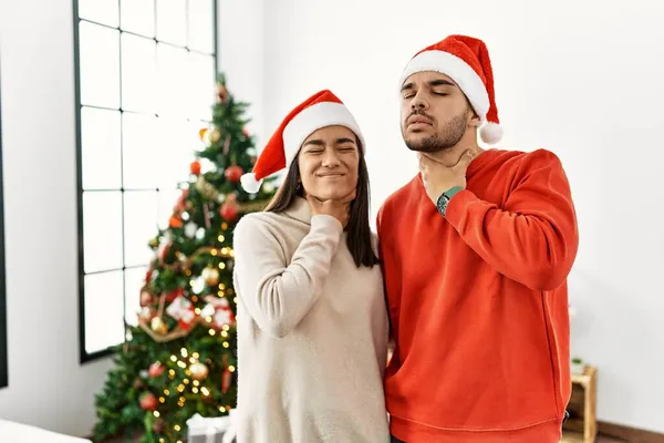Jong Hispanic Paar Stand Kerstboom Aanraken Pijnlijke Nek Zere Keel — Stockfoto