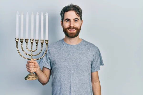 Caucasian Man Beard Holding Menorah Hanukkah Jewish Candle Looking Positive — Stock Photo, Image