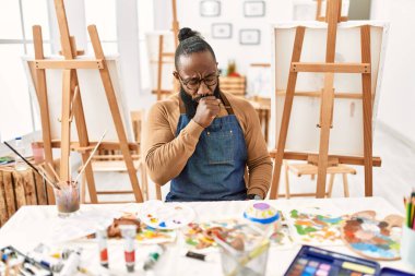 African american artist man at art studio feeling unwell and coughing as symptom for cold or bronchitis. health care concept. 