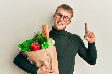 Elinde poşet dolusu yiyecek olan beyaz bir adam bir fikre ya da soru işaretine şaşırdı. 