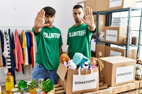 Young Gay Couple Wearing Volunteer Shirt Donations Stand Doing Stop —  Fotos de Stock