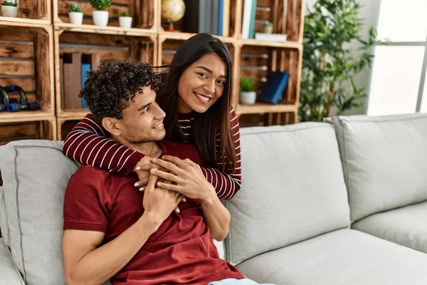 Young Latin Couple Smiling Happy Hugging Sitting Sofa Home — Stock Photo, Image