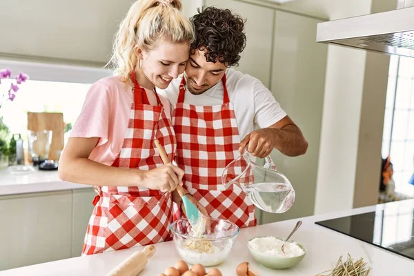Young Couple Smiling Happy Pouring Water Make Dough Homemade Bread — Stock Photo, Image