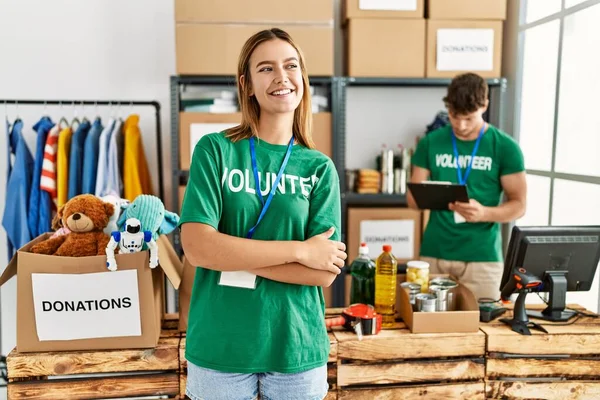 Young Blonde Girl Wearing Volunteer Shirt Donation Stand Looking Away — Fotografia de Stock