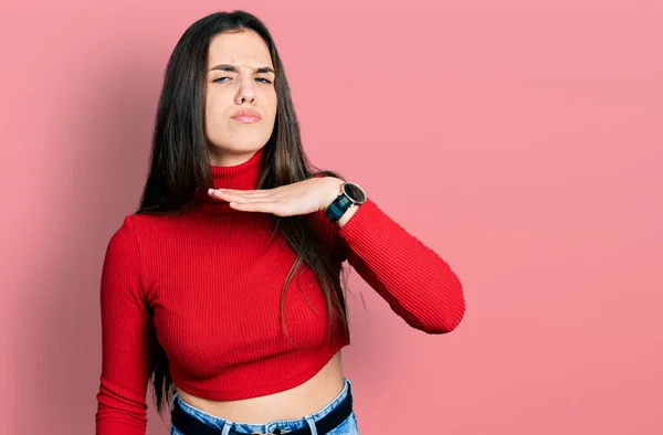 Young Brunette Teenager Wearing Red Turtleneck Sweater Cutting Throat Hand — Stockfoto