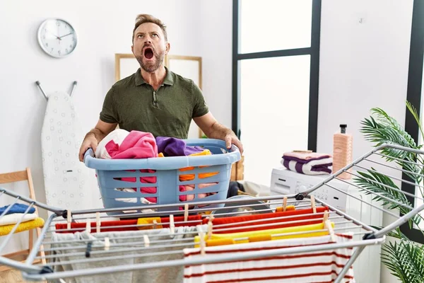 Middle Age Man Doing Laundry Holding Basket Angry Mad Screaming — 图库照片