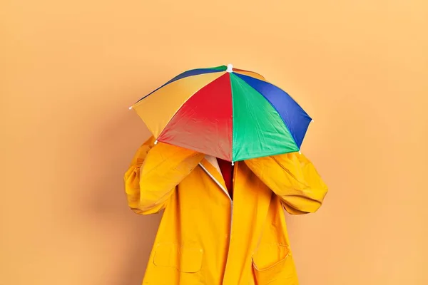 Young African American Man Wearing Yellow Raincoat Suffering Headache Desperate — Stock Photo, Image