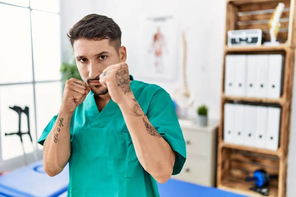 Young Physiotherapist Man Working Pain Recovery Clinic Ready Fight Fist — Fotografia de Stock