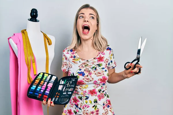 Beautiful Caucasian Woman Dressmaker Designer Holding Scissors Sewing Kit Angry — Stockfoto