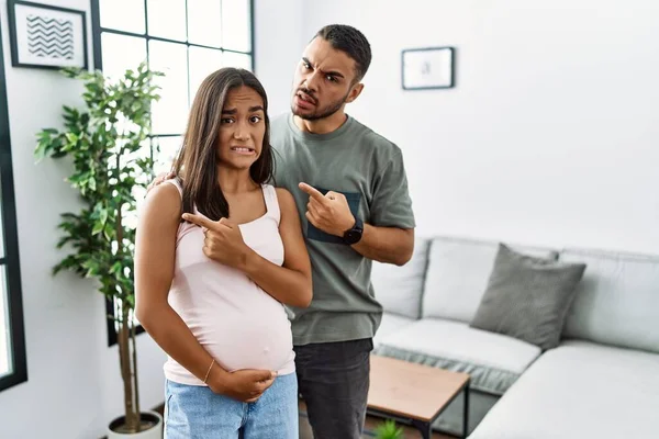 Young Interracial Couple Expecting Baby Touching Pregnant Belly Pointing Aside — Stock Photo, Image