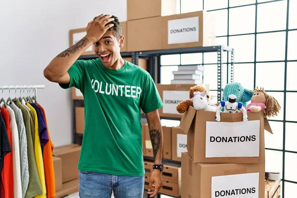 Young Handsome Hispanic Man Wearing Volunteer Shirt Donations Stand Surprised — Zdjęcie stockowe