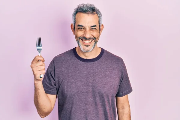 Handsome Middle Age Man Grey Hair Holding One Silver Fork — Stockfoto