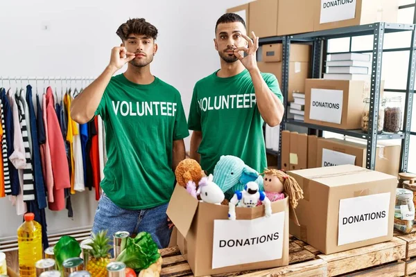 Young Gay Couple Wearing Volunteer Shirt Donations Stand Mouth Lips — Zdjęcie stockowe